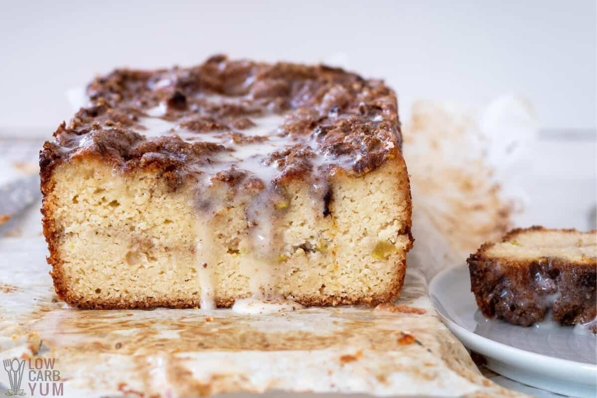 cut apple fritter bread on parchment paper with drizzle 