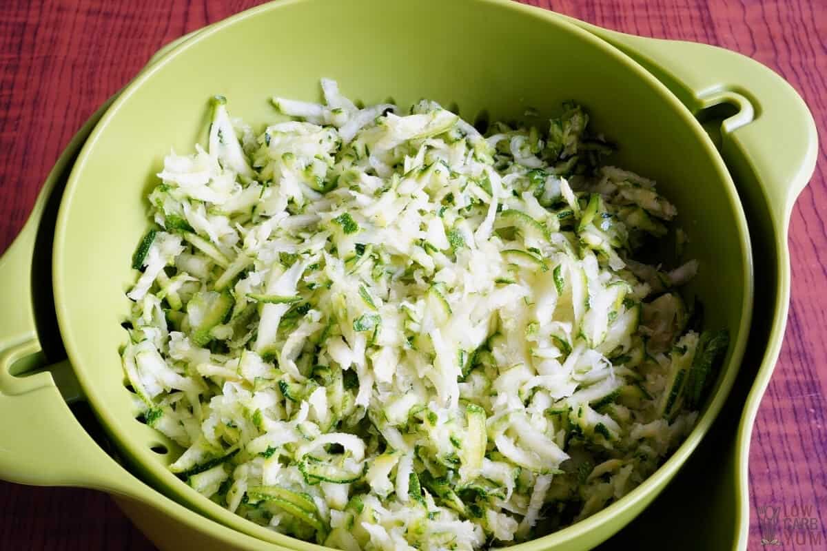 grated zucchini draining in colander