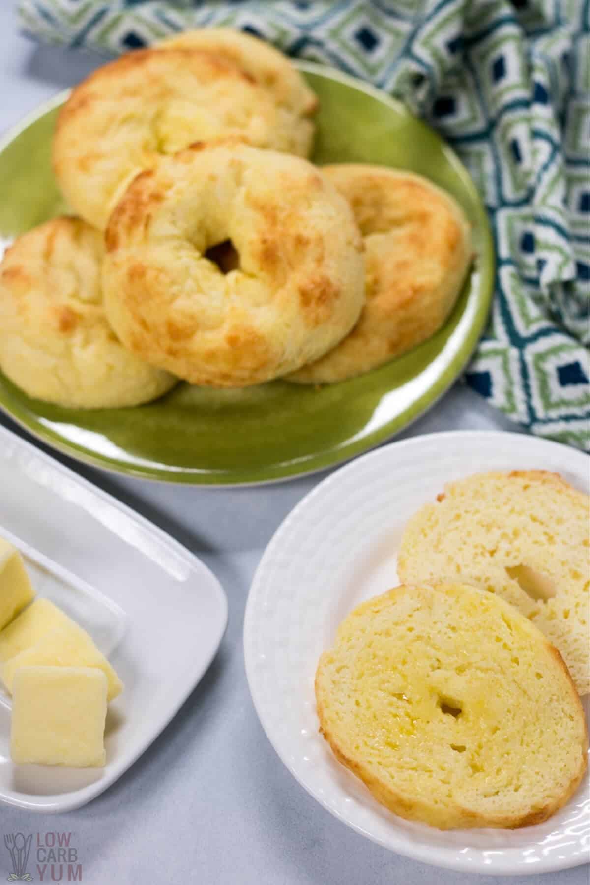 keto coconut flour fathead dough bagels on plates with butter