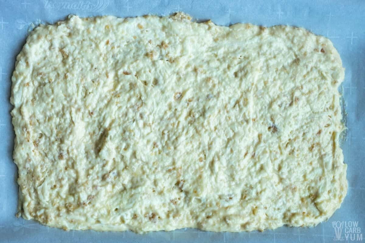 pork rind keto bread dough spread on parchment paper