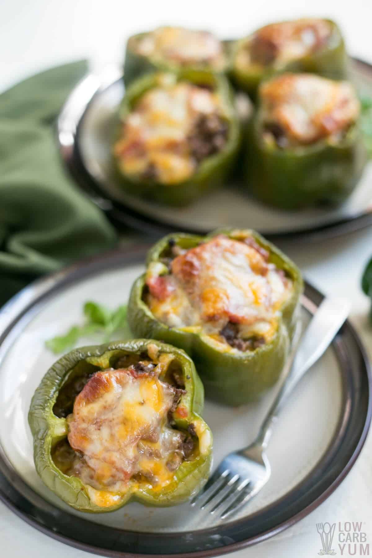green bell peppers are stuffed with keto approved ground beef and cheeses