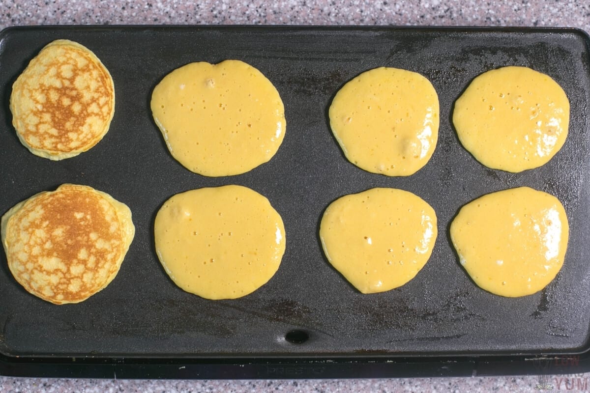 cooking coconut flour pancakes on griddle