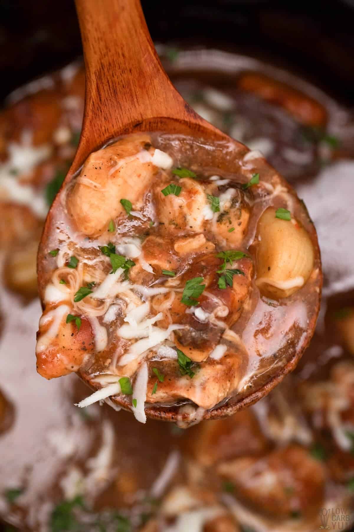 crockpot pizza casserole on wooden spoon