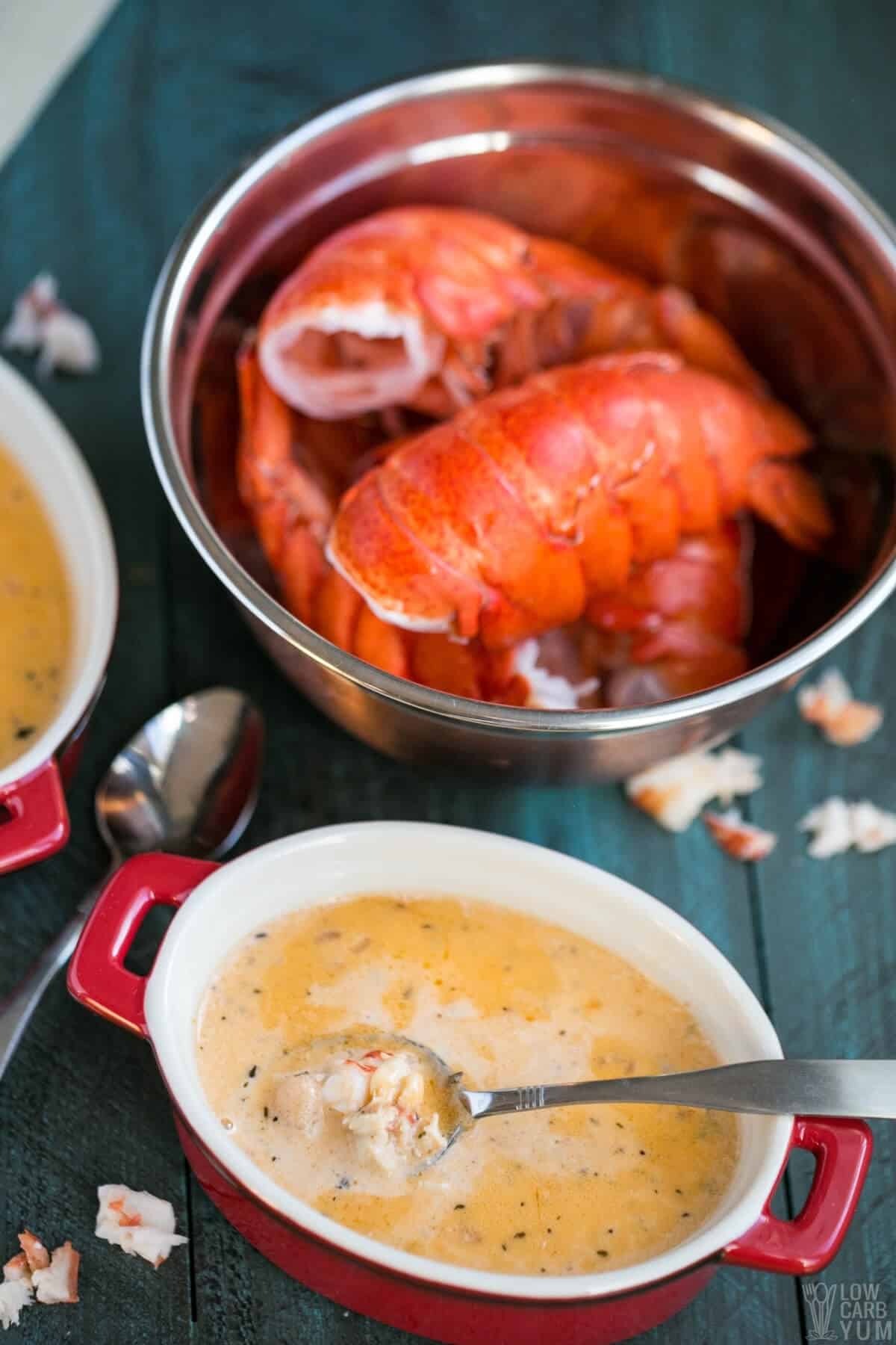 keto lobster bisque in personal crock with lobster meat on spoon