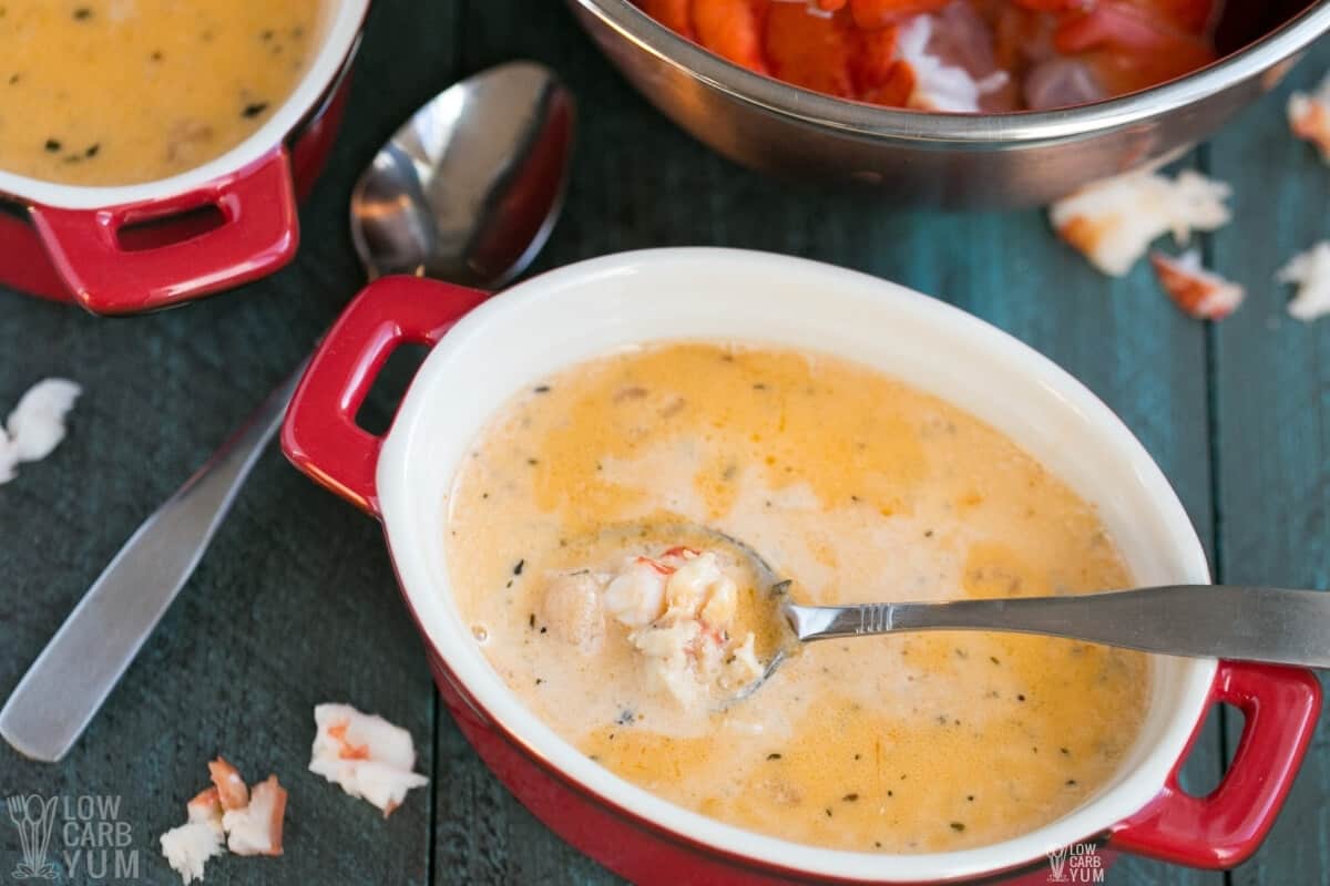 closeup of lobster bisque soup in serving pot with spoon