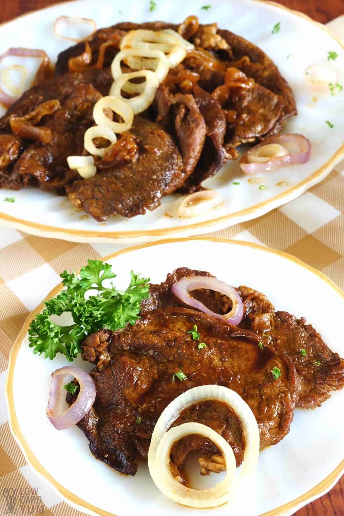 filipino bistek on plate and platter topped with caramelized red onions 