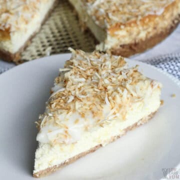 coconut cream cheesecake slice on white plate