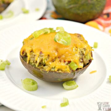 baked chicken stuffed avocado on white plate