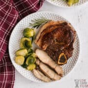 sliced berkshire pork chop on white plate