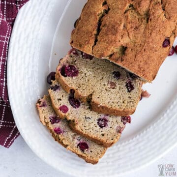 loaf of cranberry bread sliced on platter