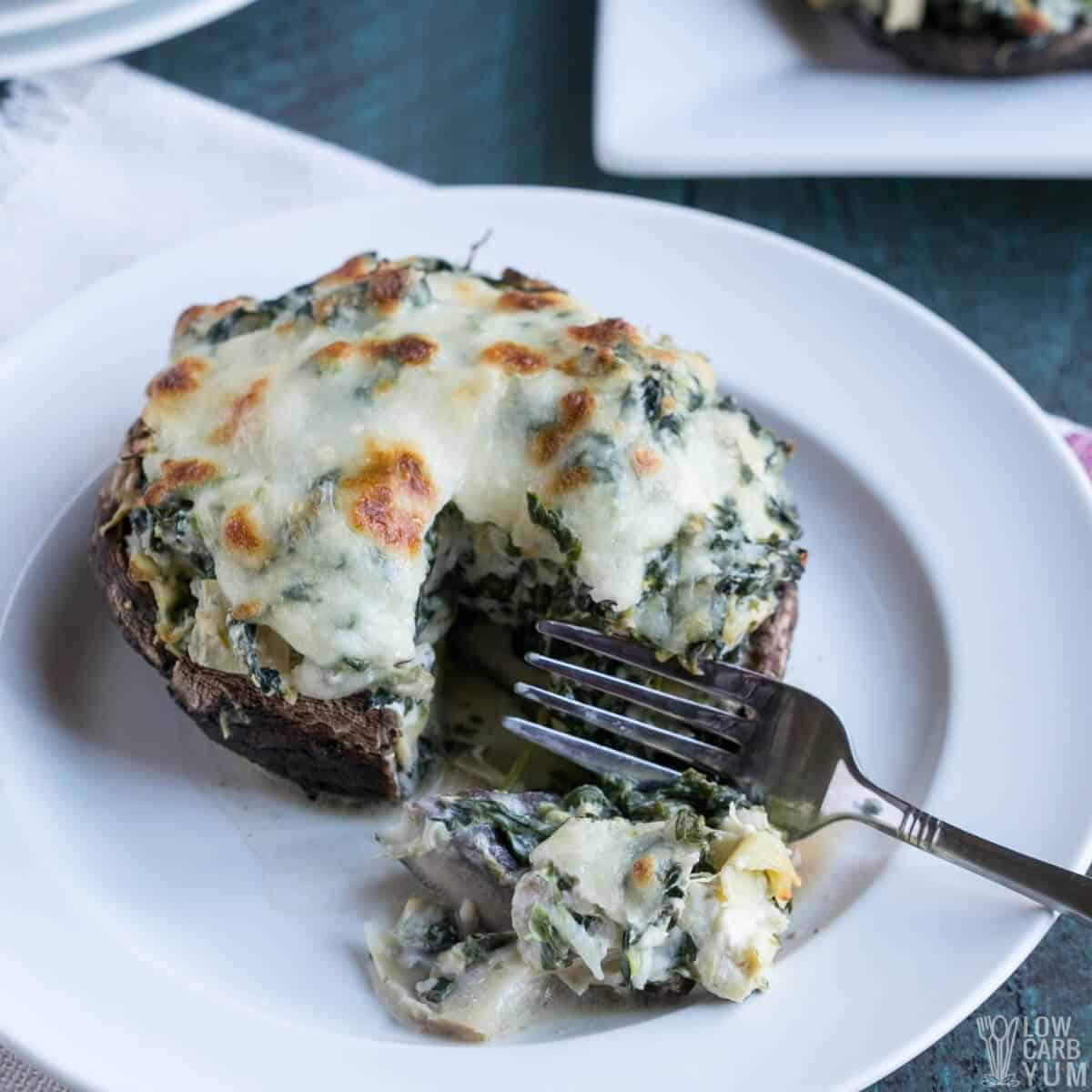 spinach stuffed portobello mushroom on plate with fork bite square image