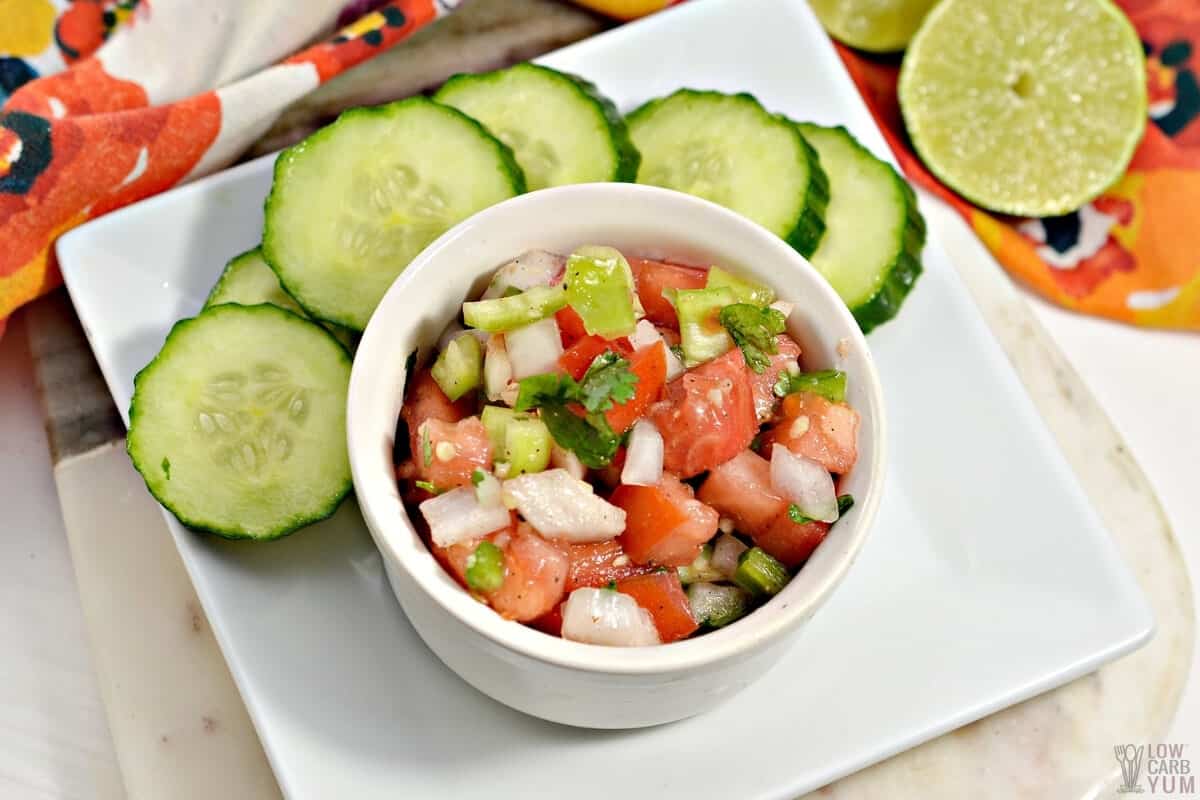 keto salsa in small bowl with cucumber slices