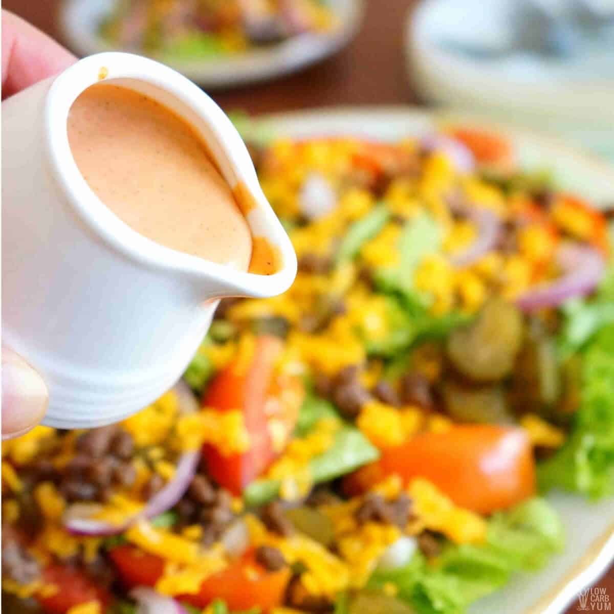 pouring dressing over salad