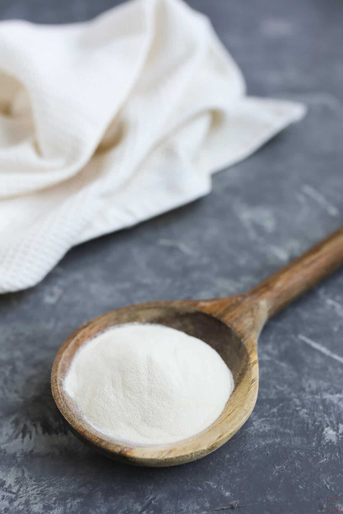 xanthan gum on large wooden spoon with white linen