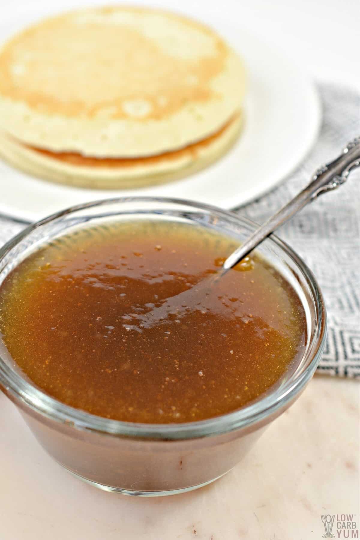 keto maple syrup in glass bowl with pancakes