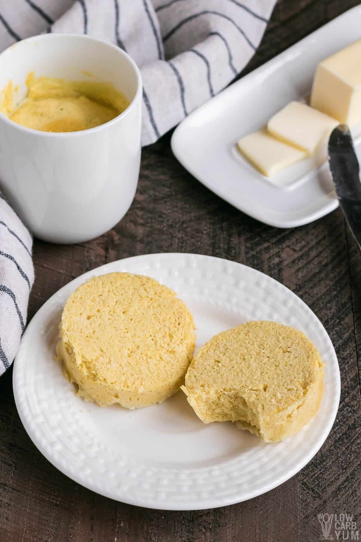 muffins on white plate with butter and muffin in a mug