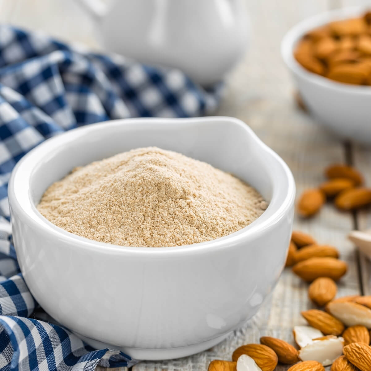 keto friendly almond flour in white bowl with nuts
