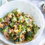broccoli salad in bowl with toppings on side