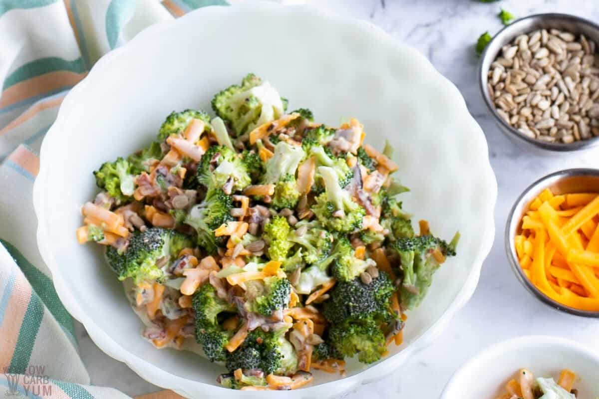 broccoli salad in bowl with toppings on side