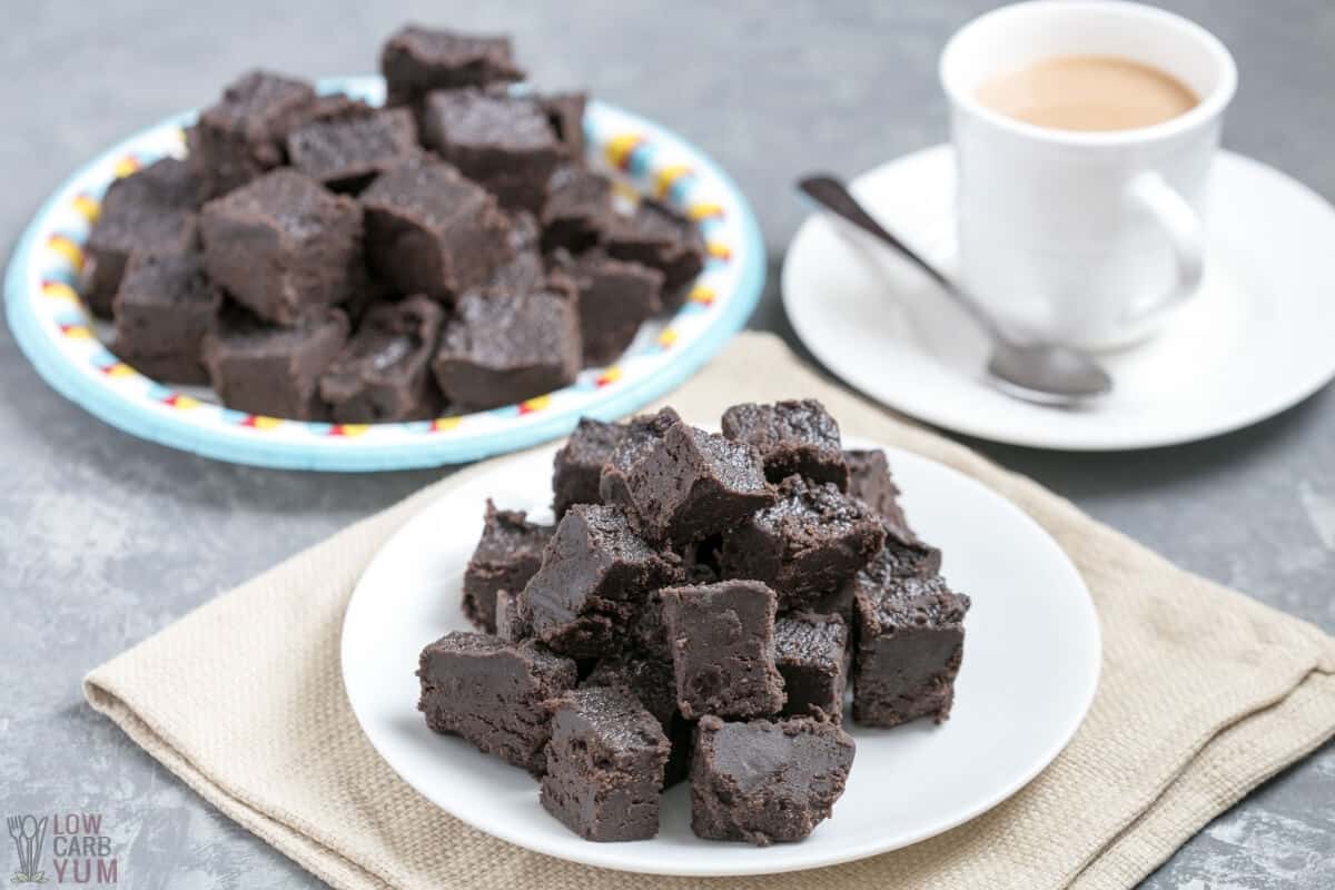 stacks of keto fudge on plates with coffee