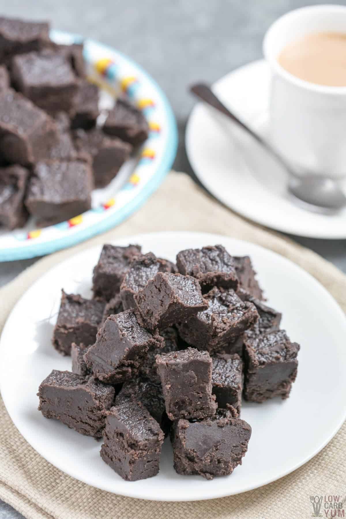 dark chocolate keto fudge squares on plates with coffee