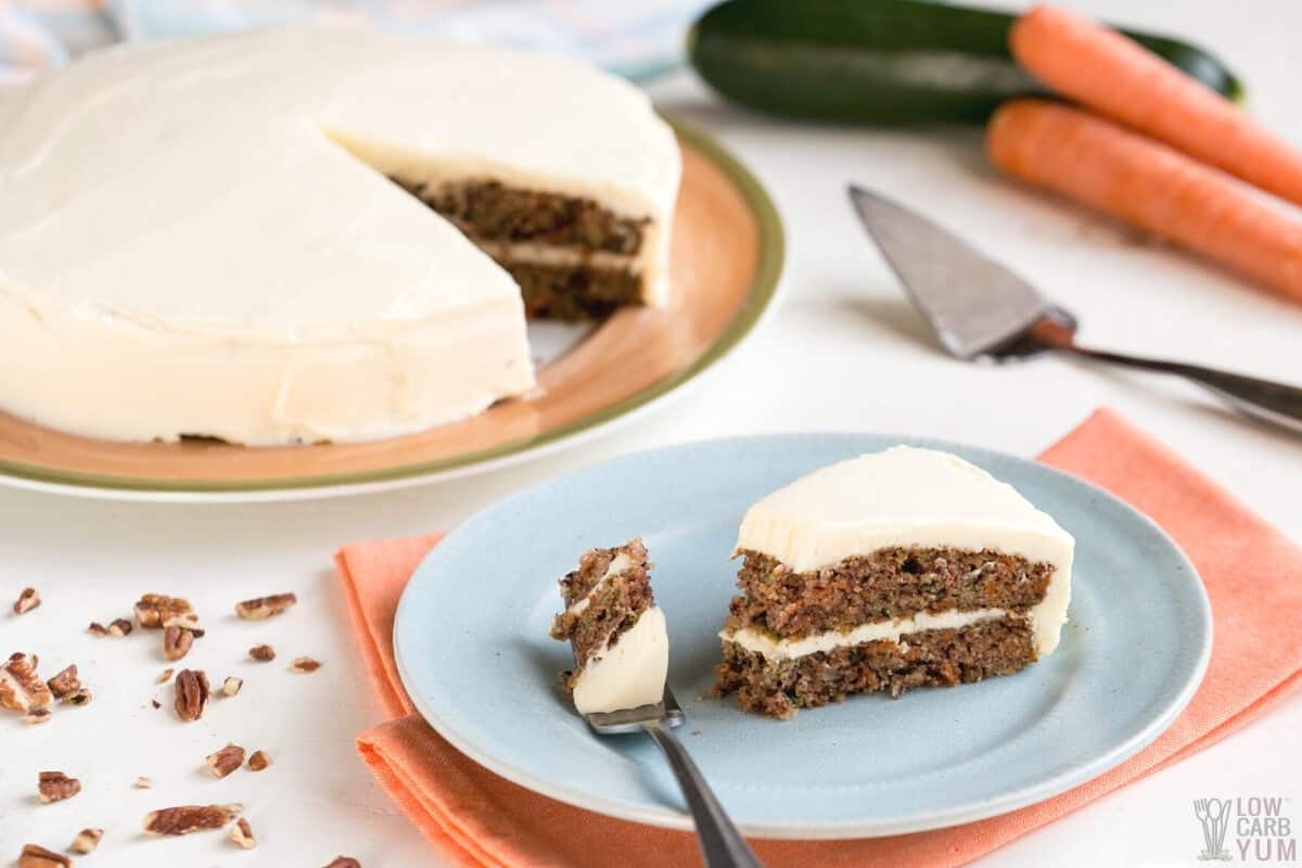 fork bite of carrot cake slice on plate