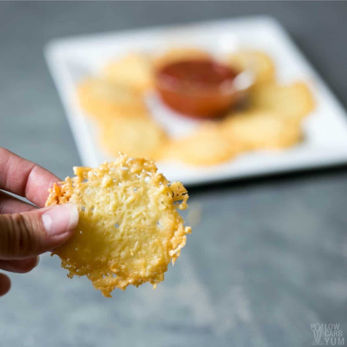 closeup holding a cheese crisp