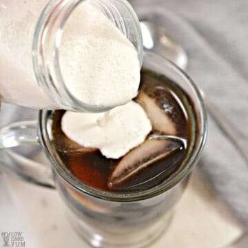 pouring creamer into ice coffee