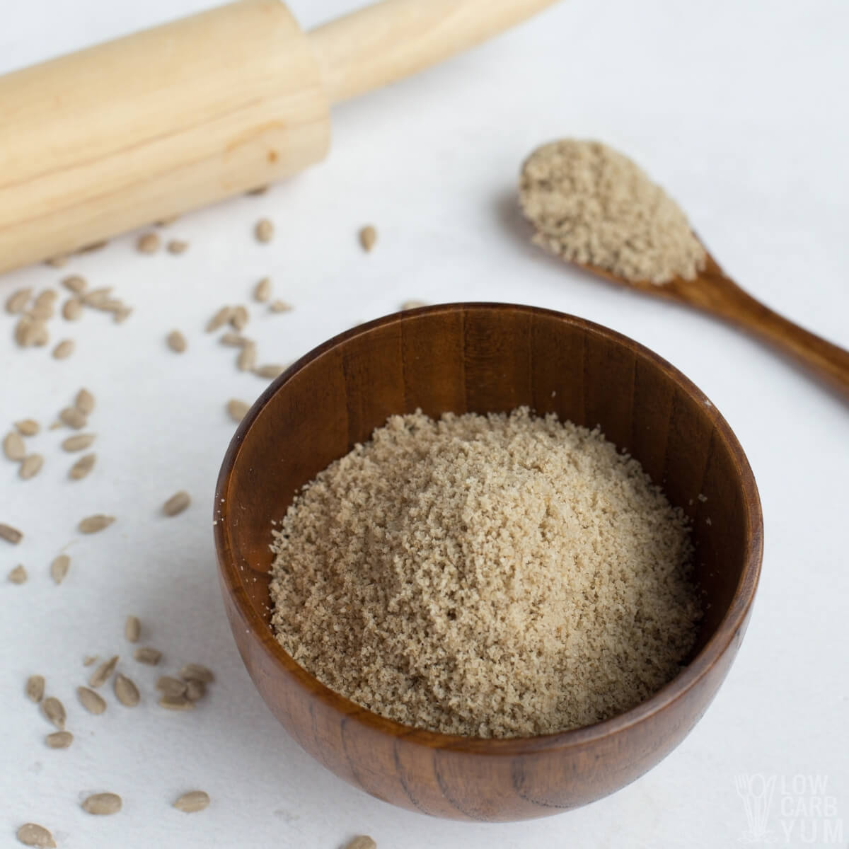 low carb sunflower seed flour in wood bowl and on spoon