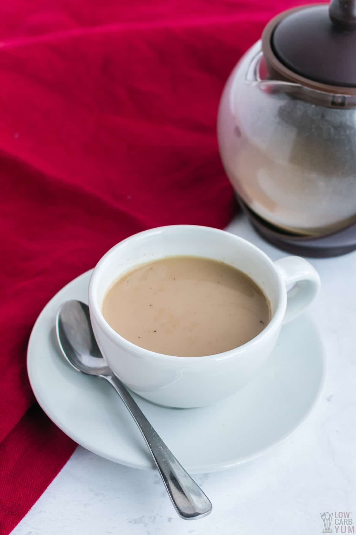 tea poured into cup with teapot