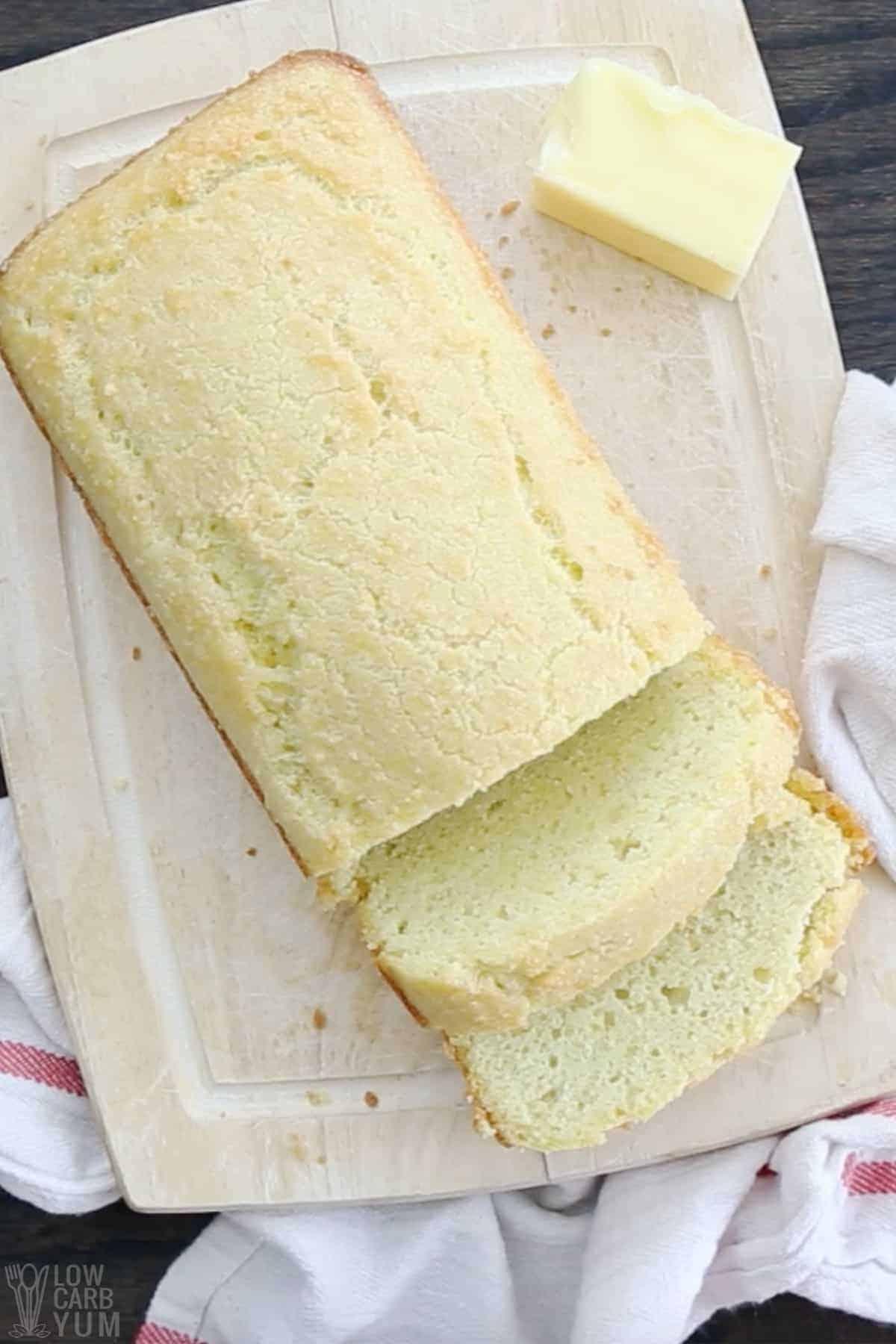 quick keto bread loaf sliced on cutting board with butter