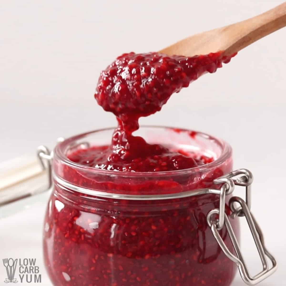 chia sugar free raspberry jam on spoon over jar