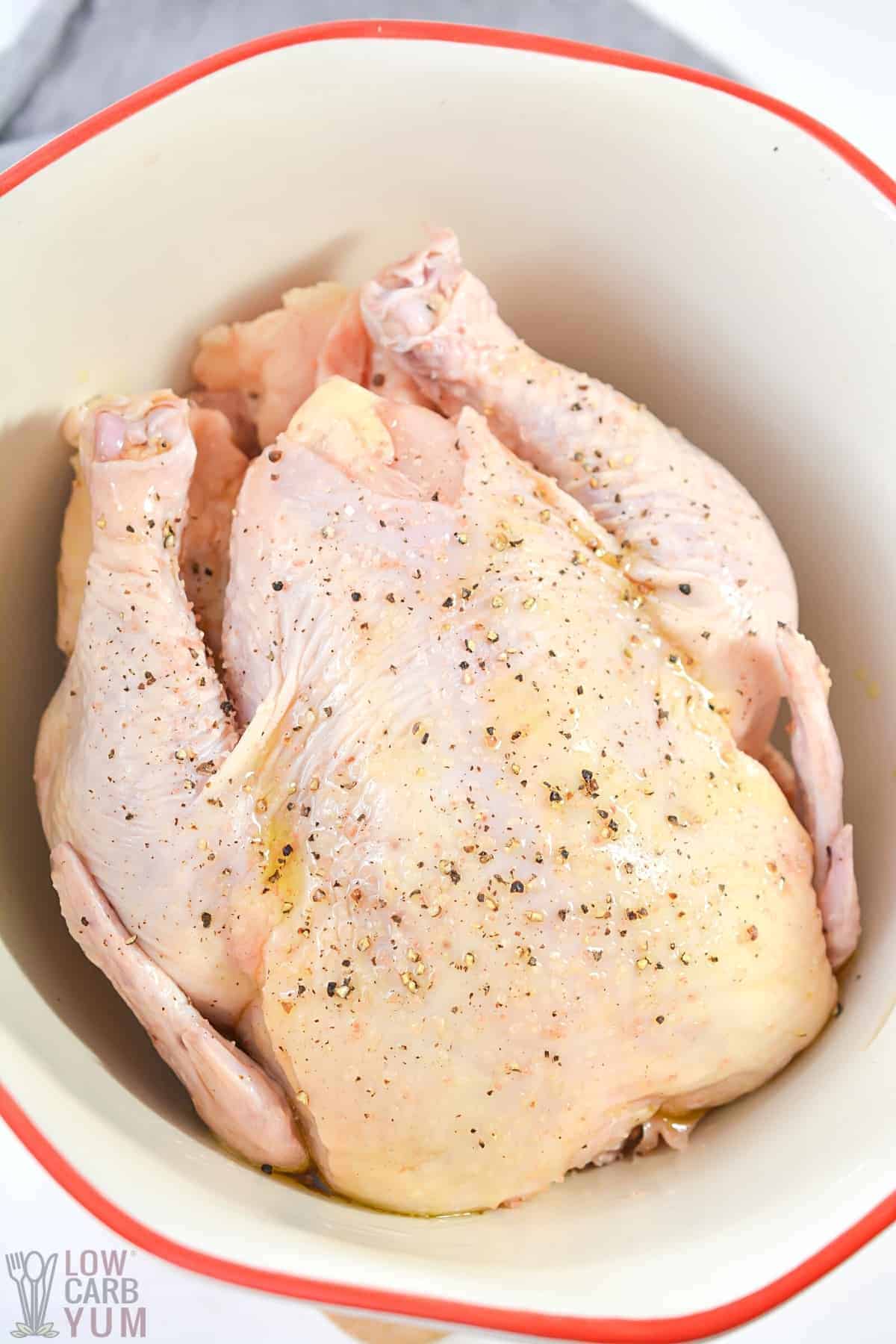 preparing whole chicken for air fryer with oil and seasonings