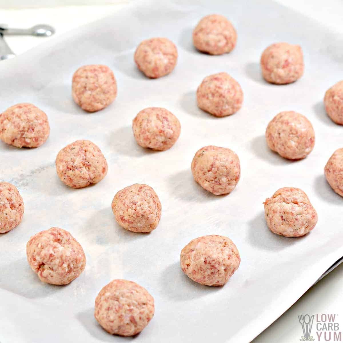 raw sausage balls on lined baking sheet