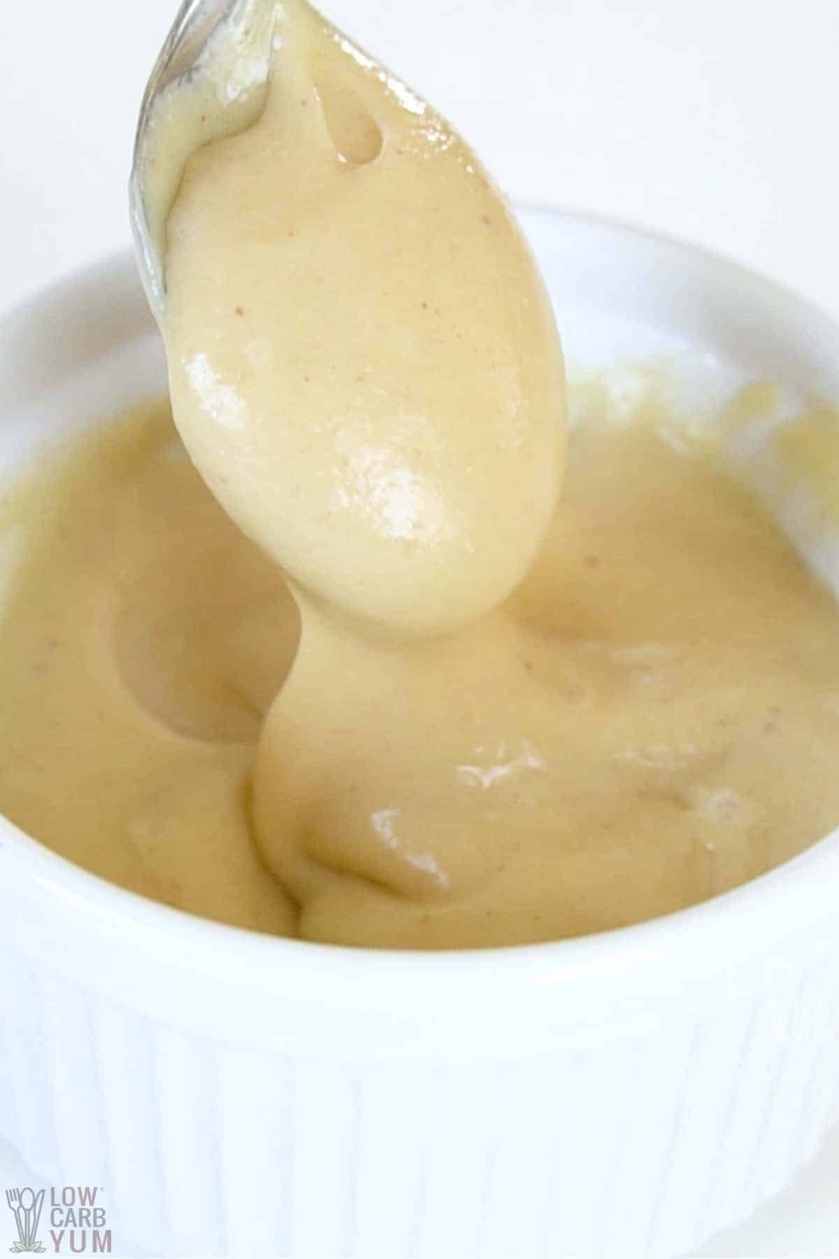 sugar free caramel sauce on spoon over ramekin