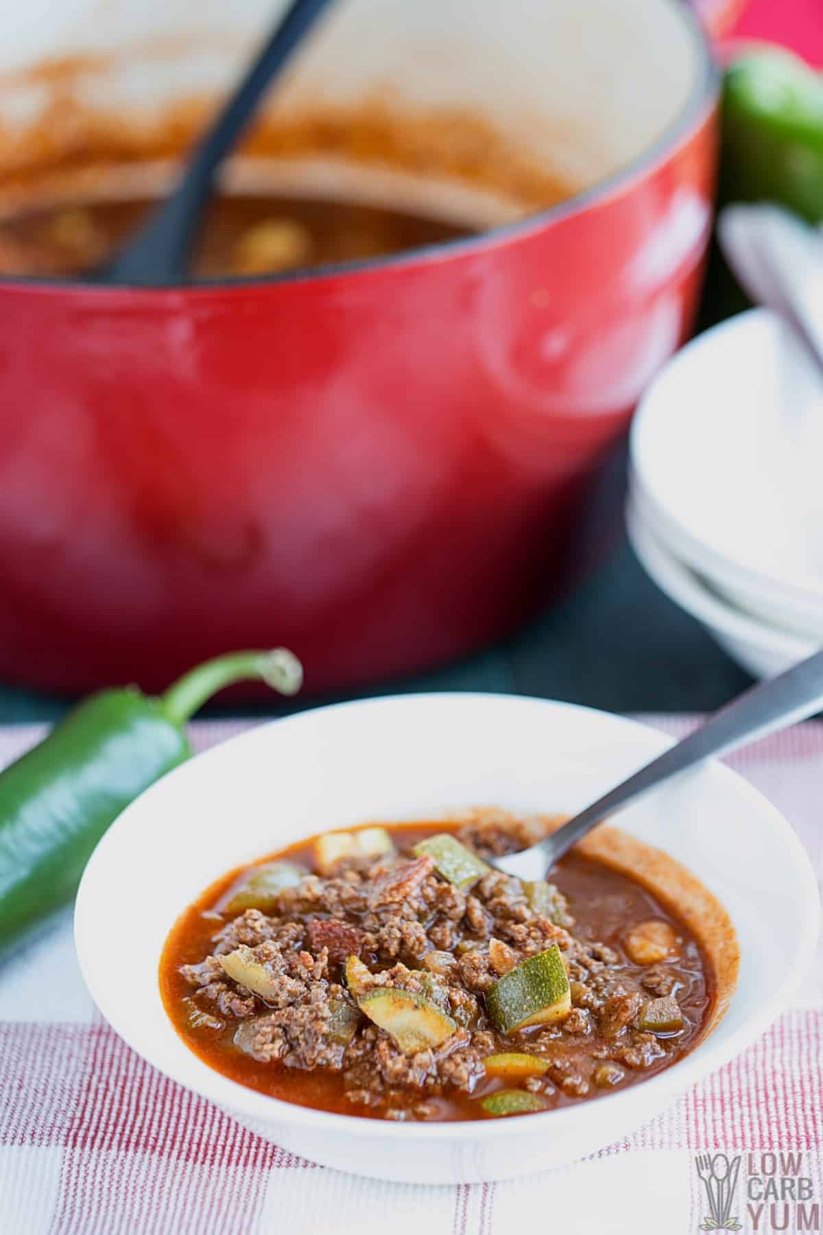 serving venison chili in white bowl