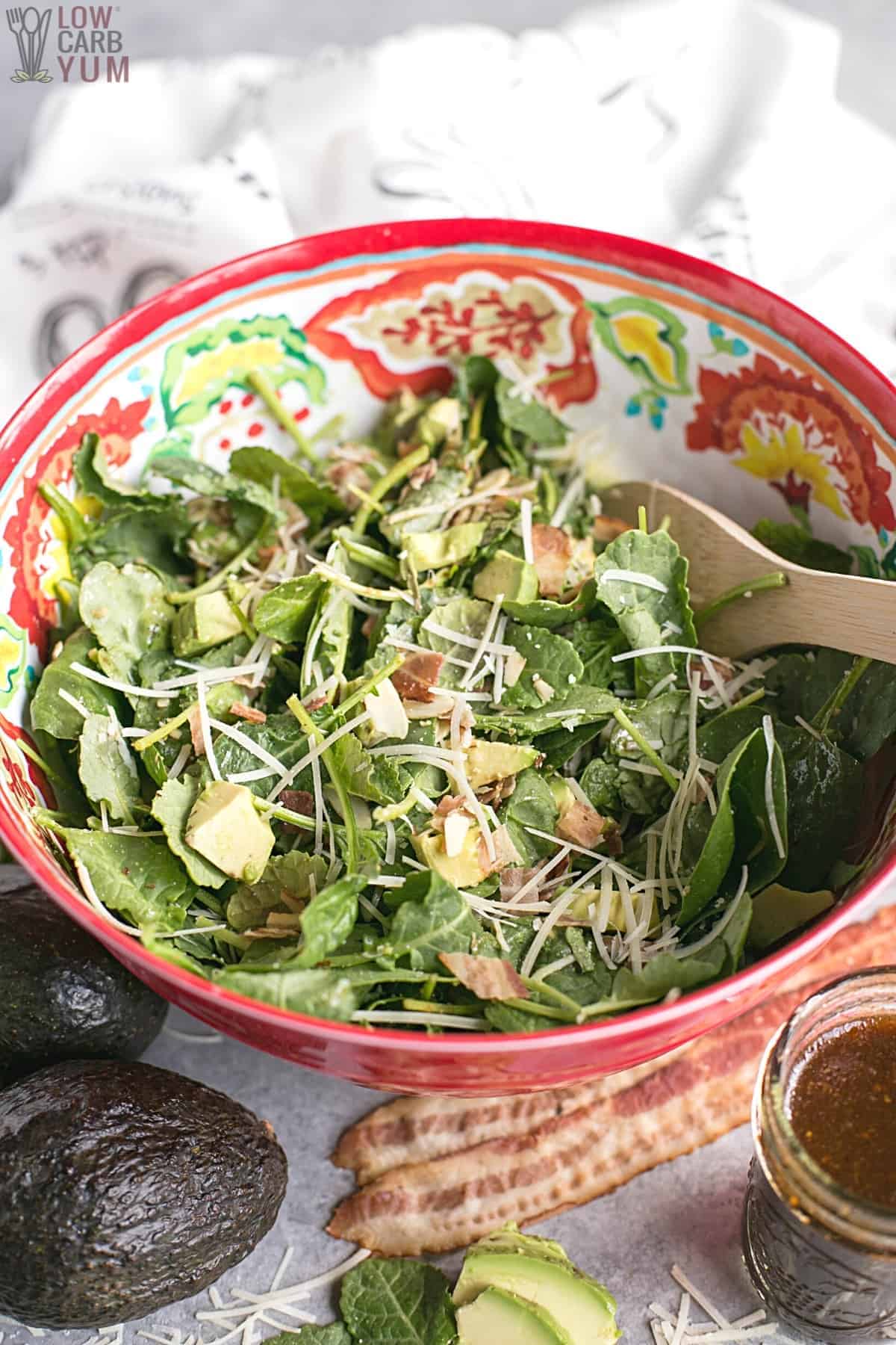 finished salad in large red patterned bowl