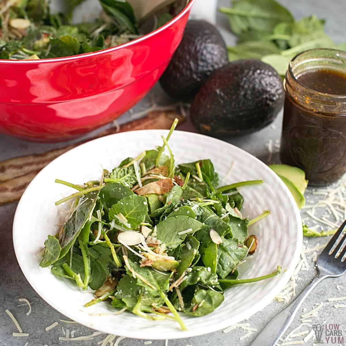 baby kale avocado salad on serving plate