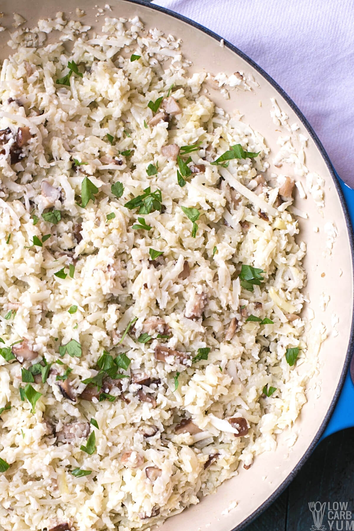 tall image of cauliflower rice mushroom risotto in pan