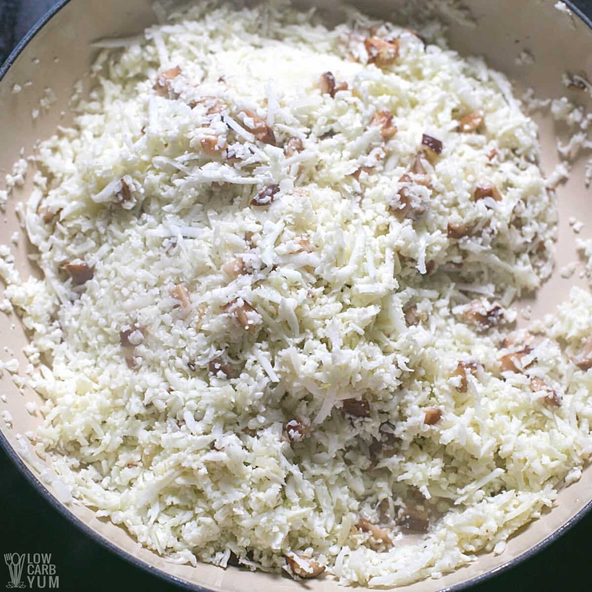 cauliflower rice and mushrooms in pan