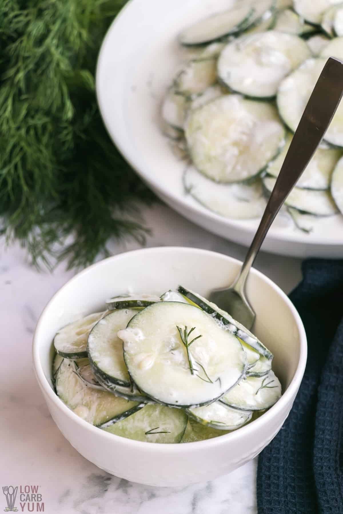 creamy cucumber dill salad in white bowls