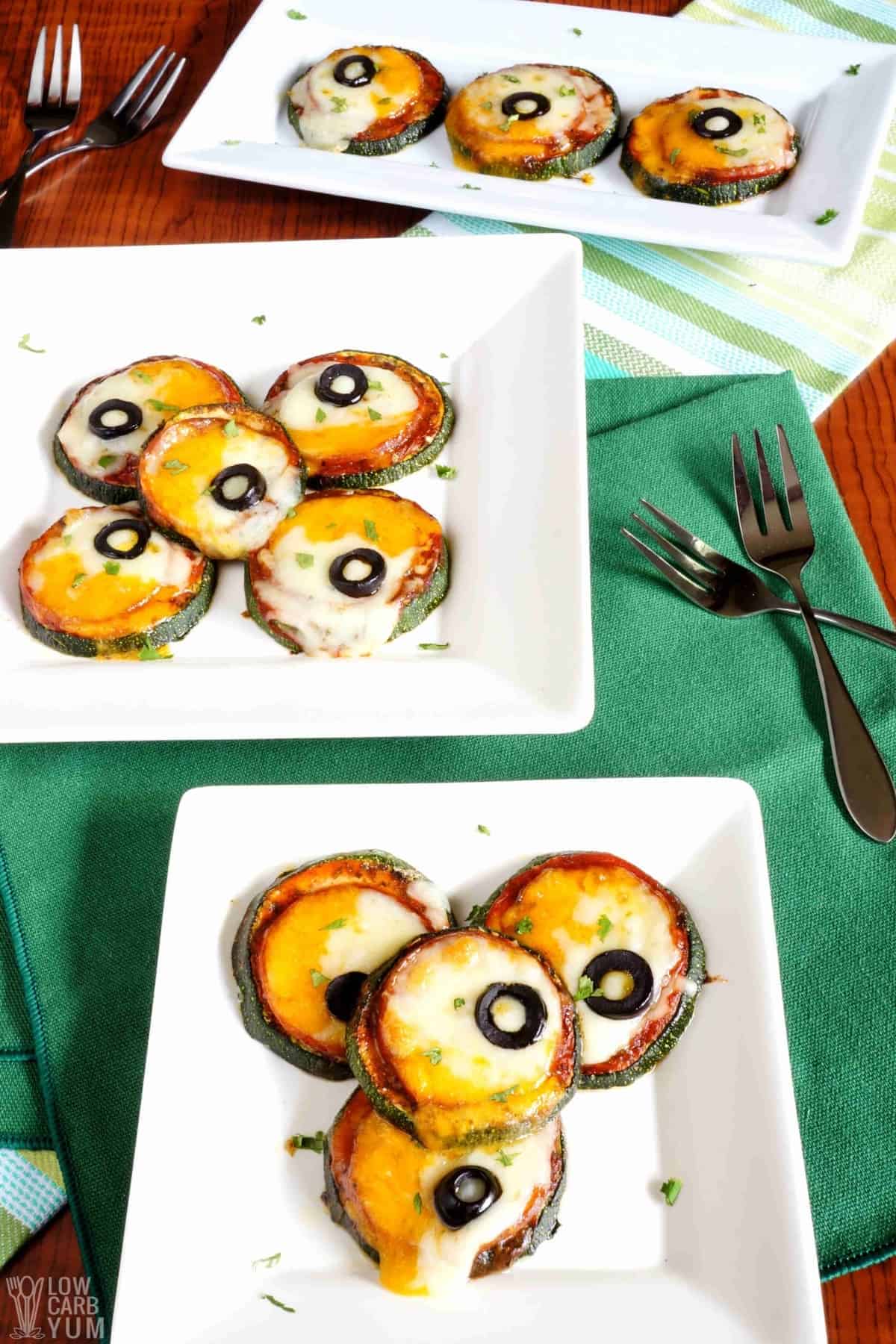 zucchini pizza bites hero image on white plates