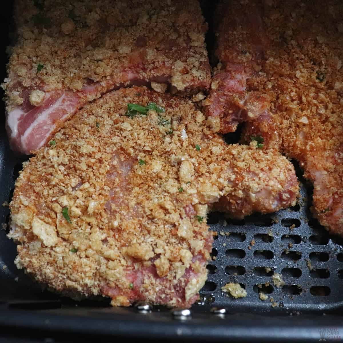 coated pork chops in air fryer basket