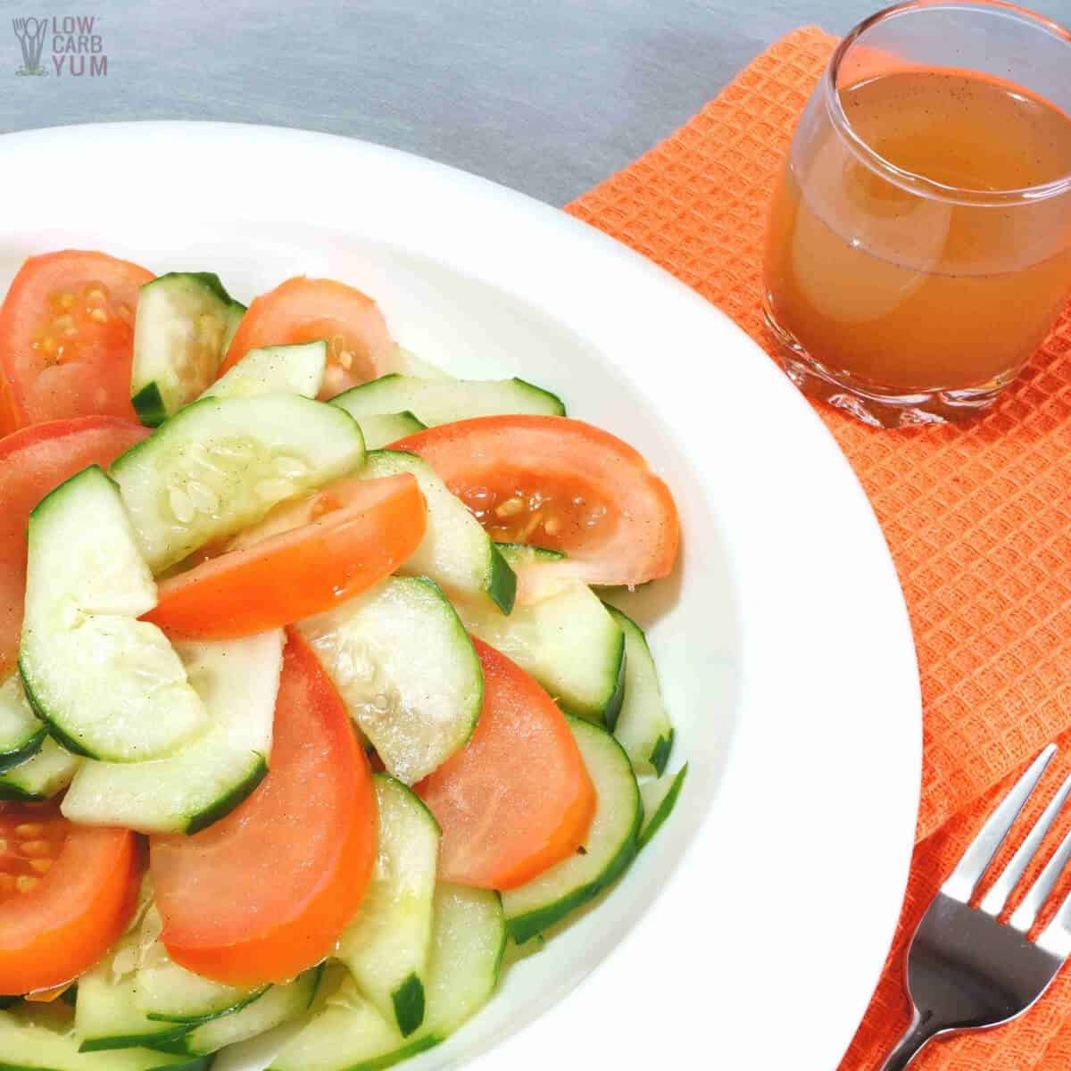 serving cucumber tomato salad with dressing