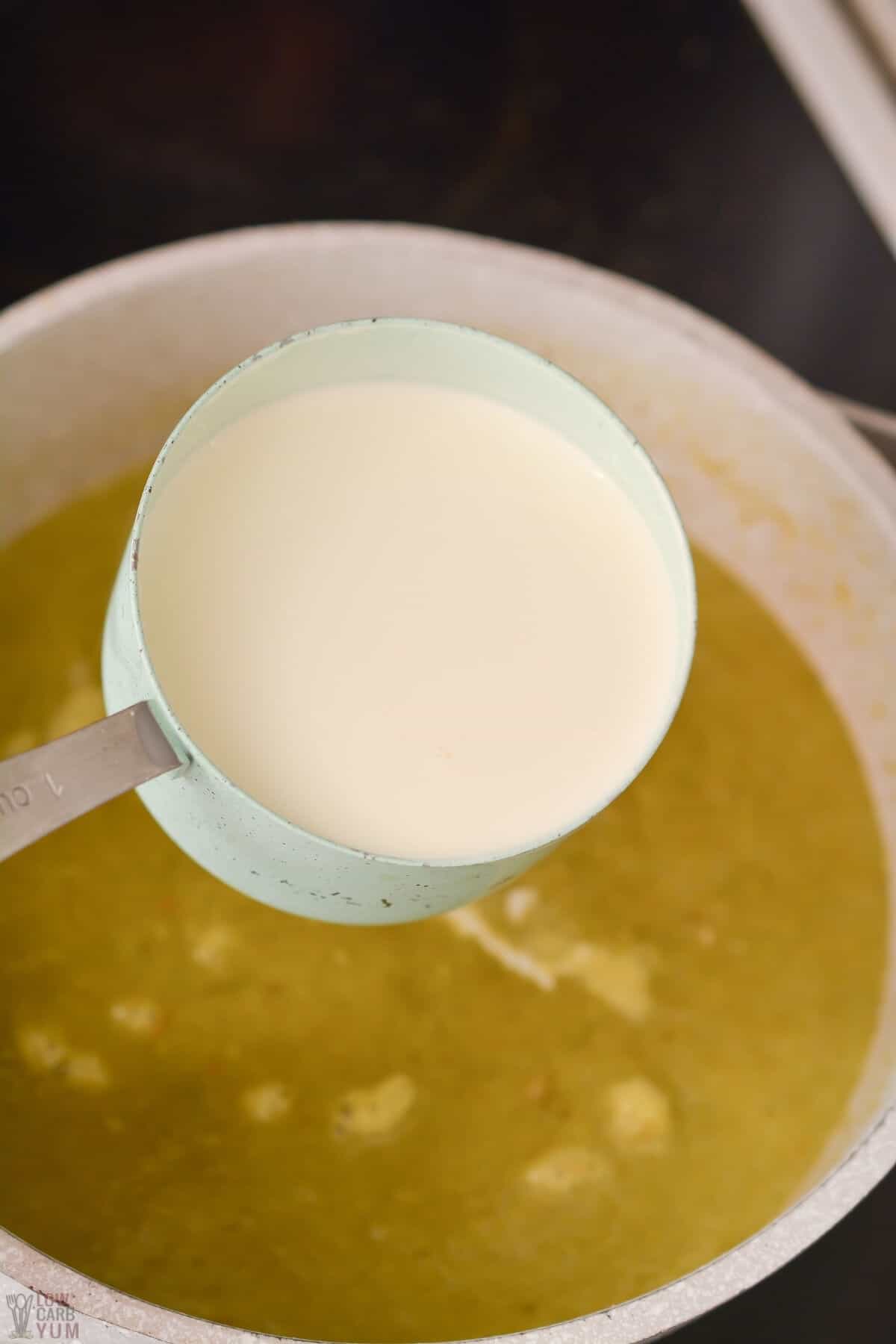 adding heavy cream to blended soup base