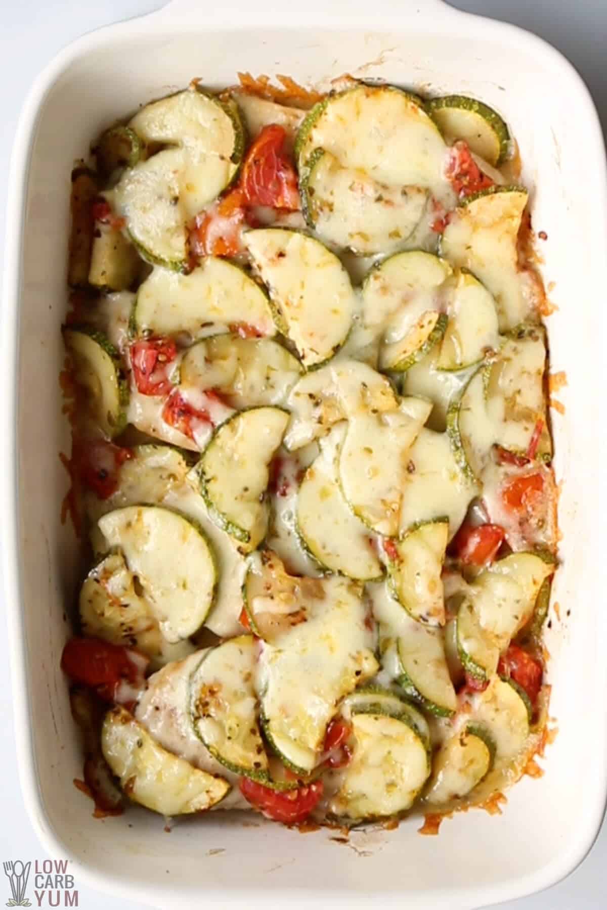 cheesy zucchini slices are baked with tomatoes for keto side dish