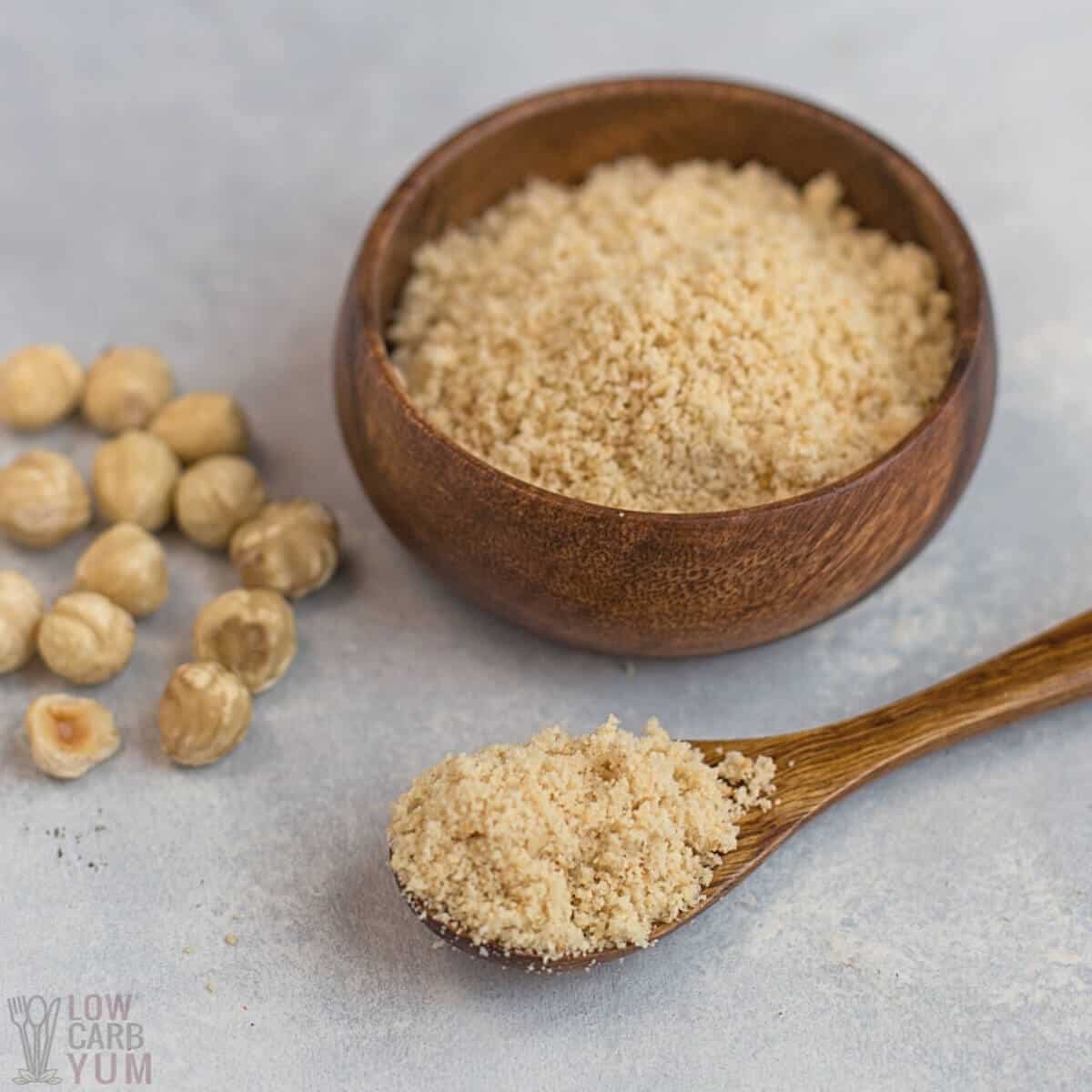 hazelnut flour in bowl and spoon with nuts