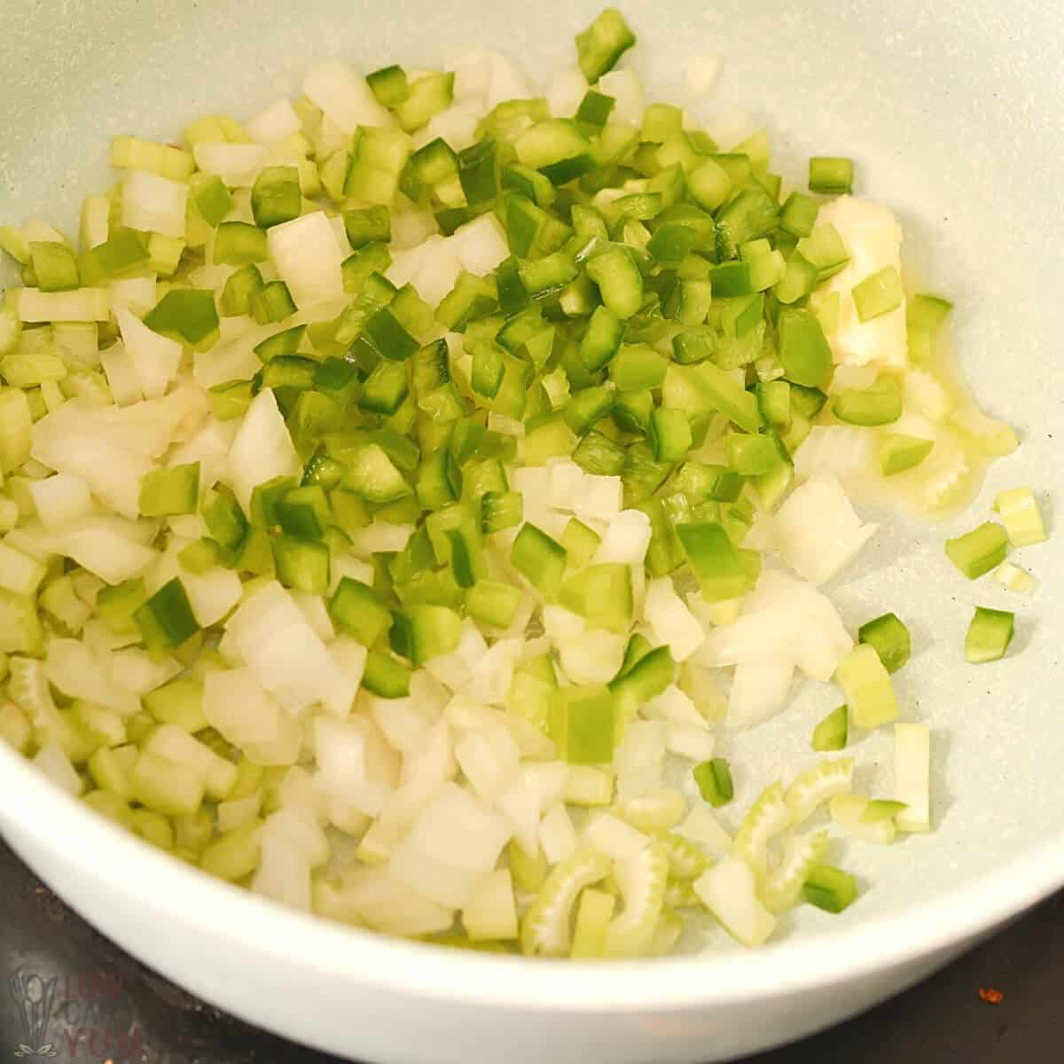 cooking onions celery and pepper in pan