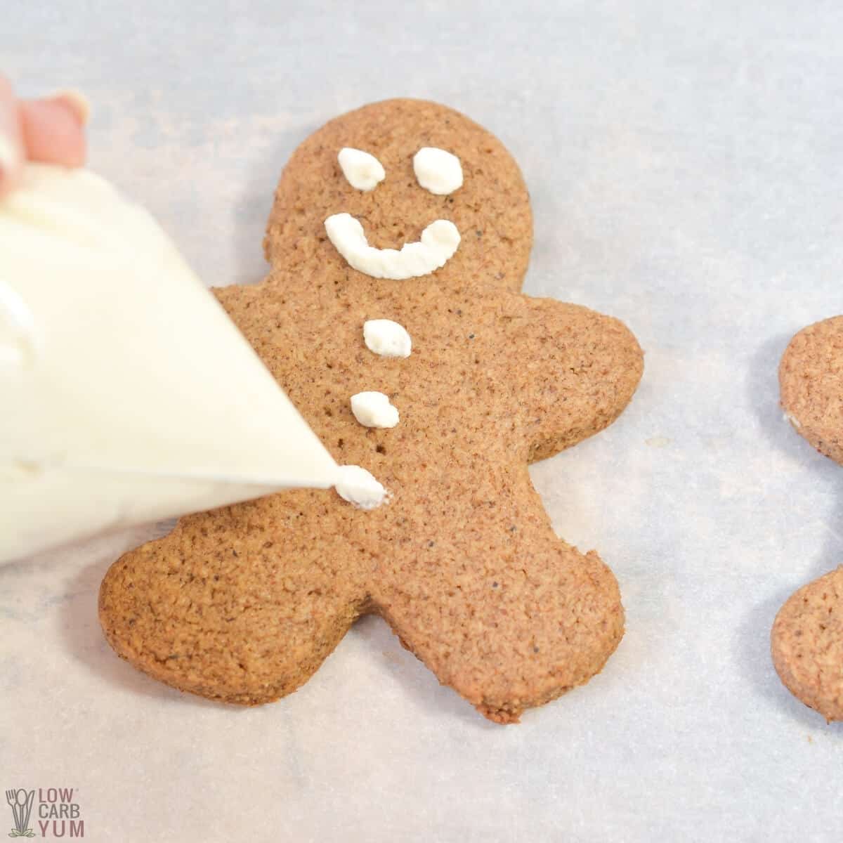 decorating a baked gingerbread man cookie