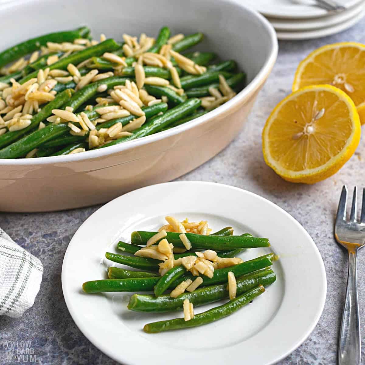 serving green beans almondine on white plate